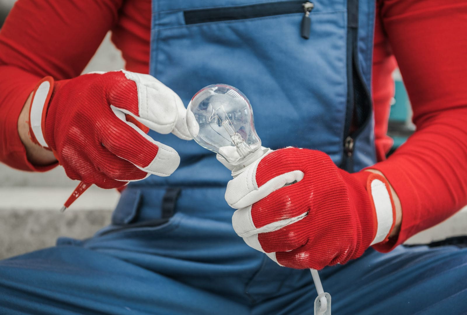 Electrician installing a light bulb.