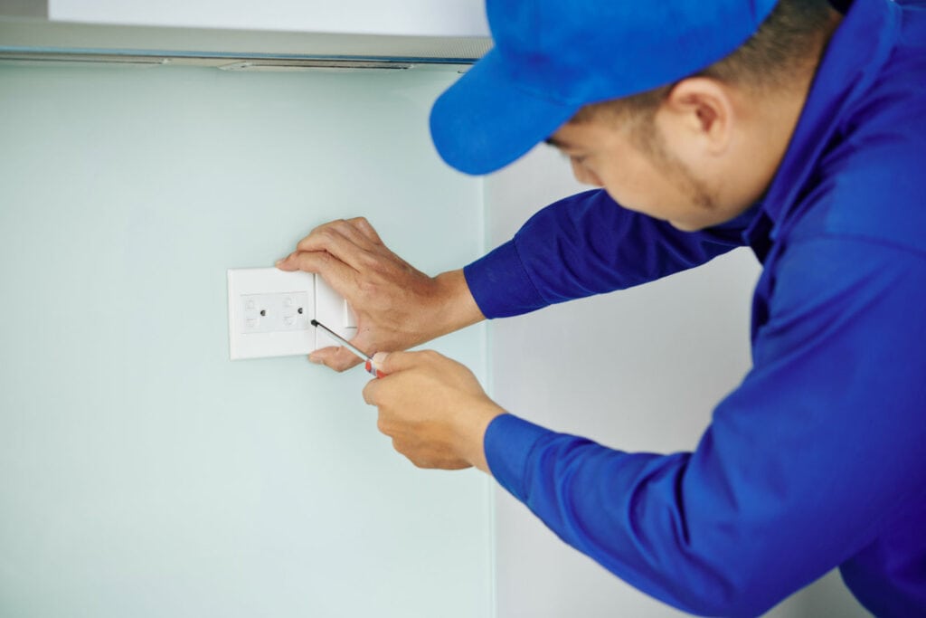 Electrician installing a power socket.